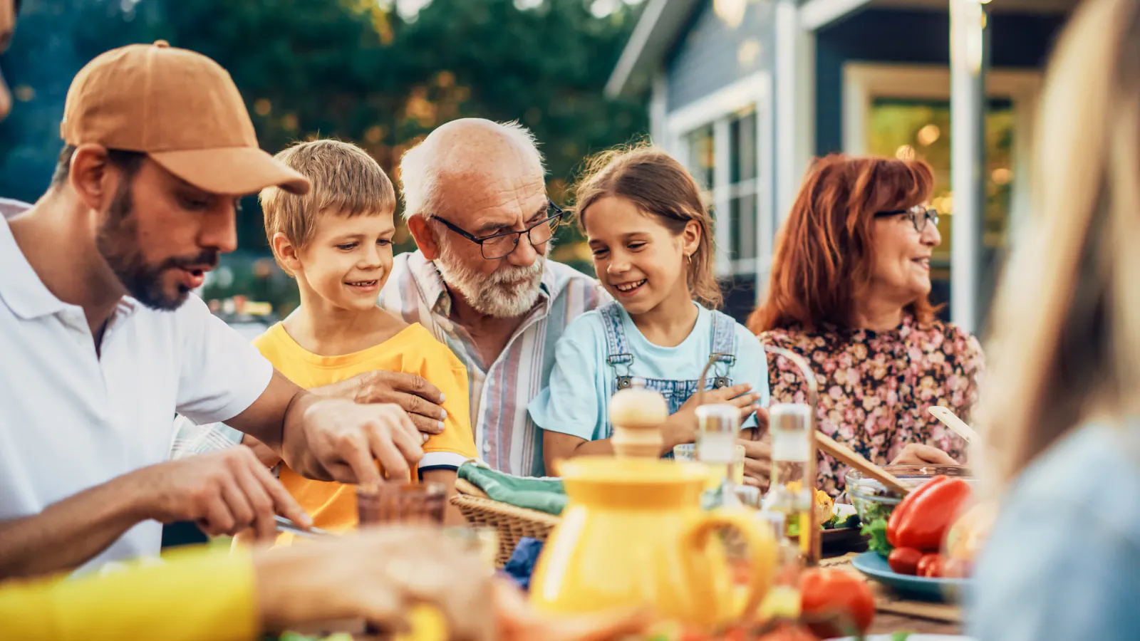 Family sharing a relaxed Spring meal together outdoors